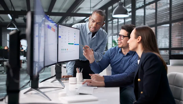 Finance team analyzing data on large monitor – Synergos Capital AG Tech-Logistics Merger and Acquisition 1.2B enterprise value